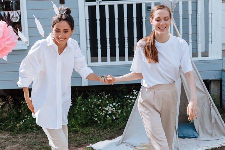 Smiling Women Holding Hands