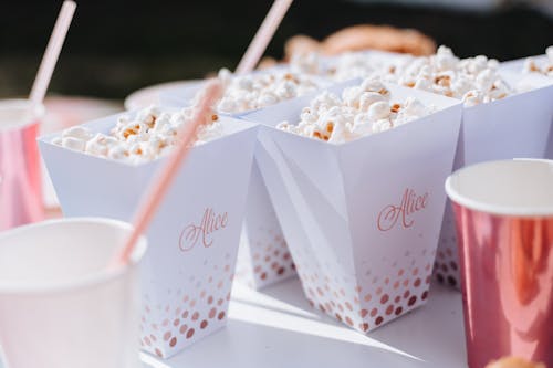Close-up Photo of Popcorn in White Popcorn Boxes