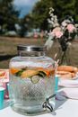 Selective Focus of a Glass Drink Dispenser Containing Lemonade Drink
