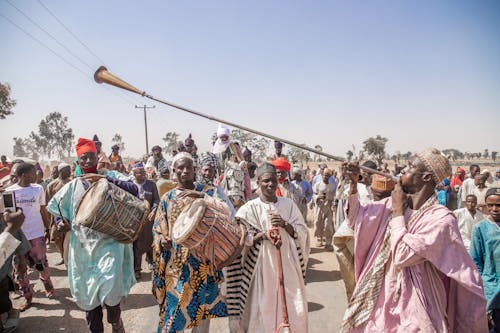 People in Traditional Dress Performing on Street