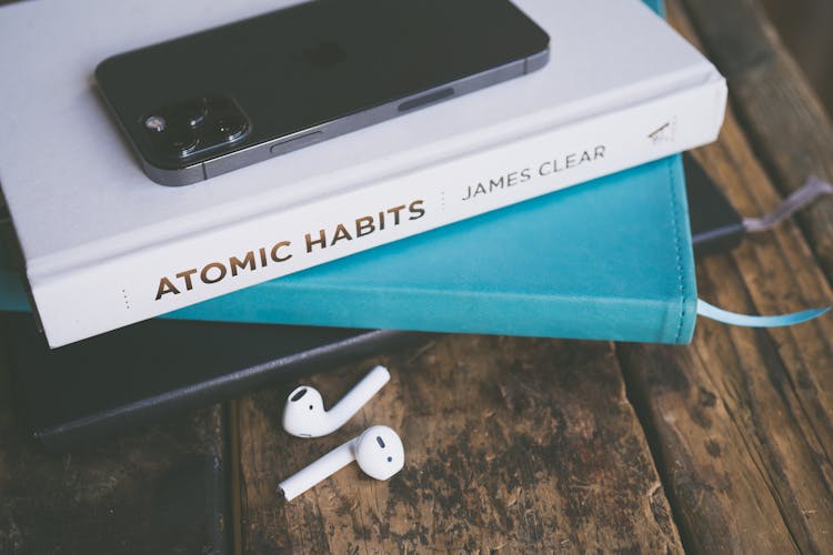 Books, IPhone And AirPods On A Table 