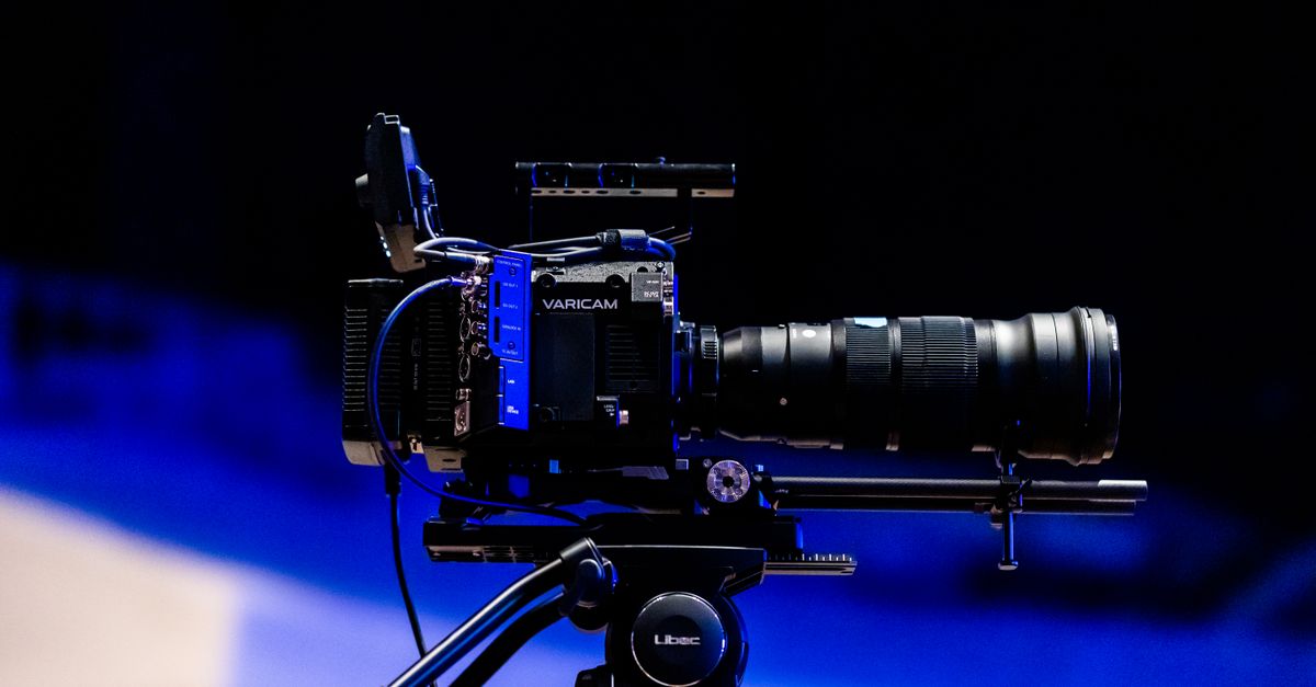 A professional video camera on a tripod, ready for filming