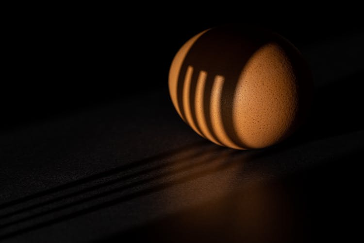 Close-up Of A Fork Shadow On An Egg 