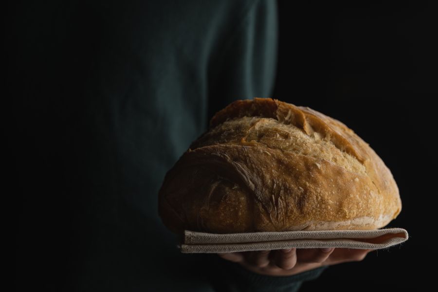 Dark loaves of bread cooling on a rack, photo by Skyler Ewing on Pexels