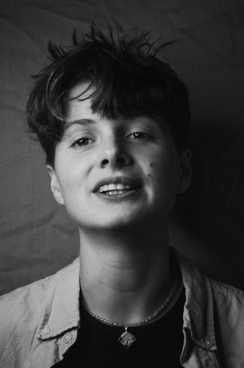 Black and White Photo of a Woman with Short Hair Looking at the Camera