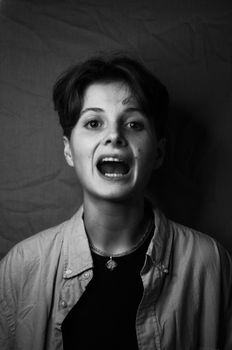 Black and white portrait of a woman with short hair and expressive facial features.