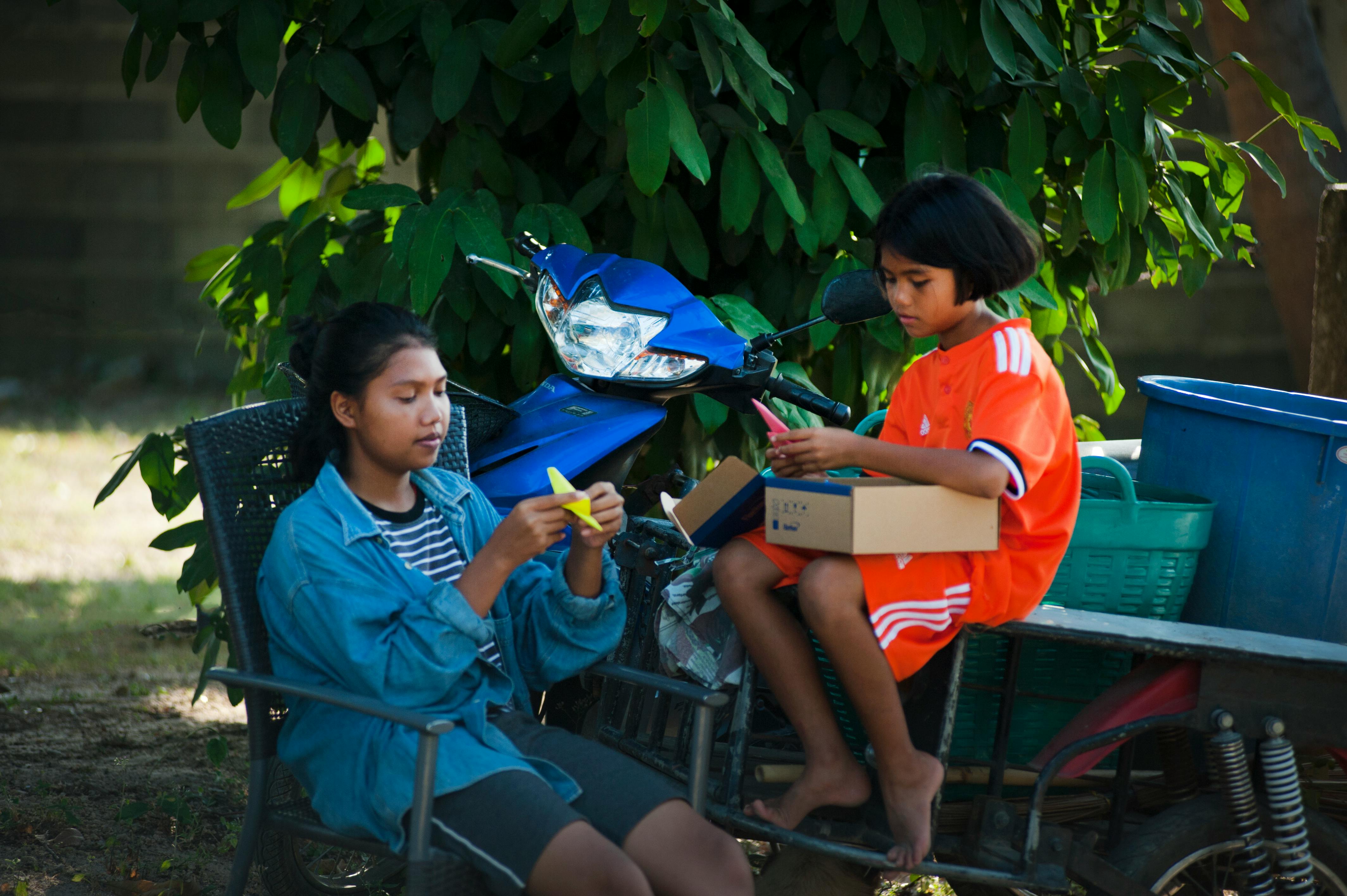 two girls doning hand crafts