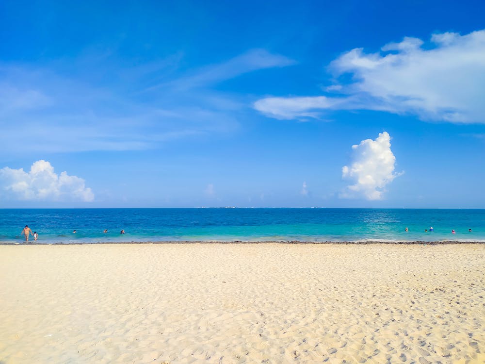 White Sand Beach Under Blue Sky