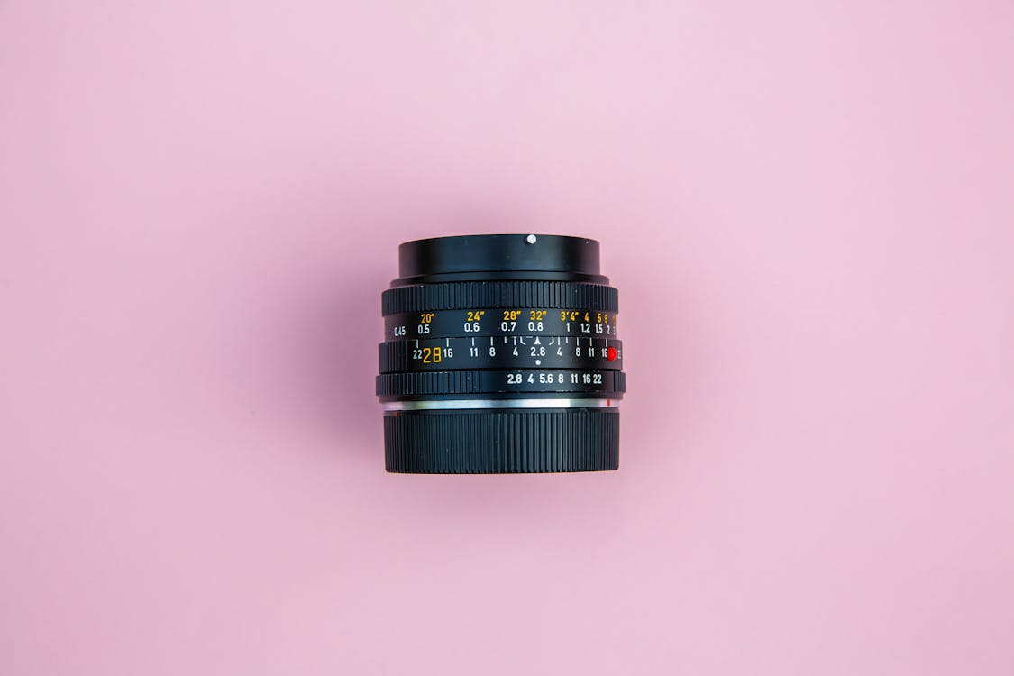 Free Black Camera Lens on Pink Surface Stock Photo