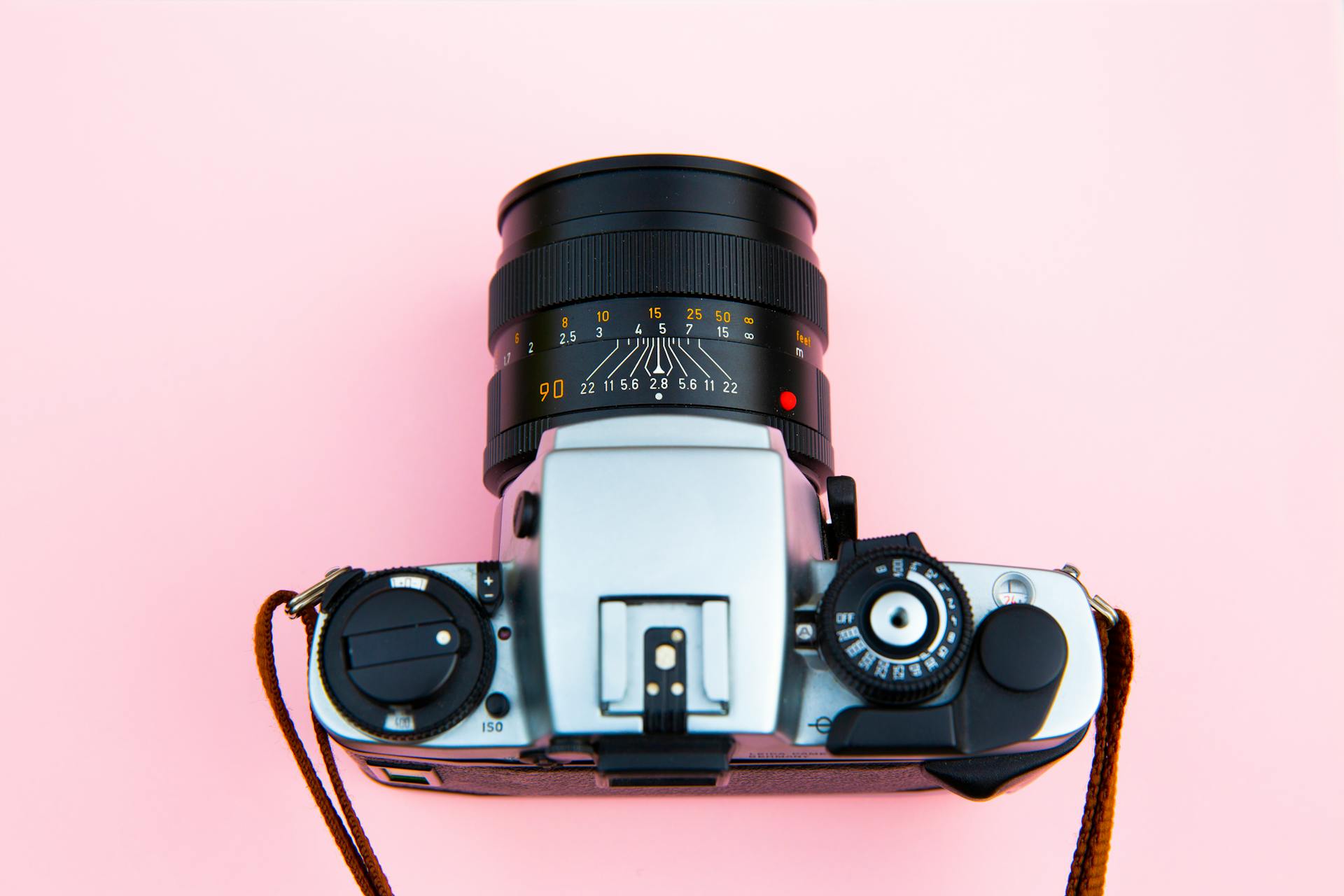 Black and Silver Camera on Brown Wooden Table