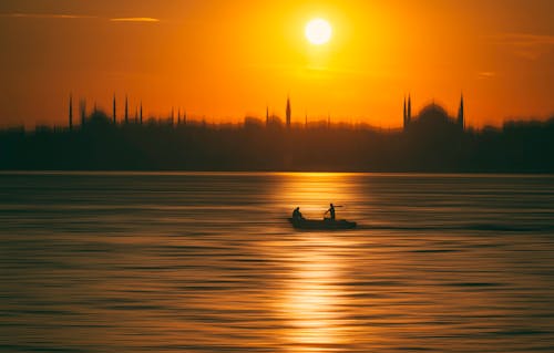 Silhouette of People Riding on Boat during Sunset