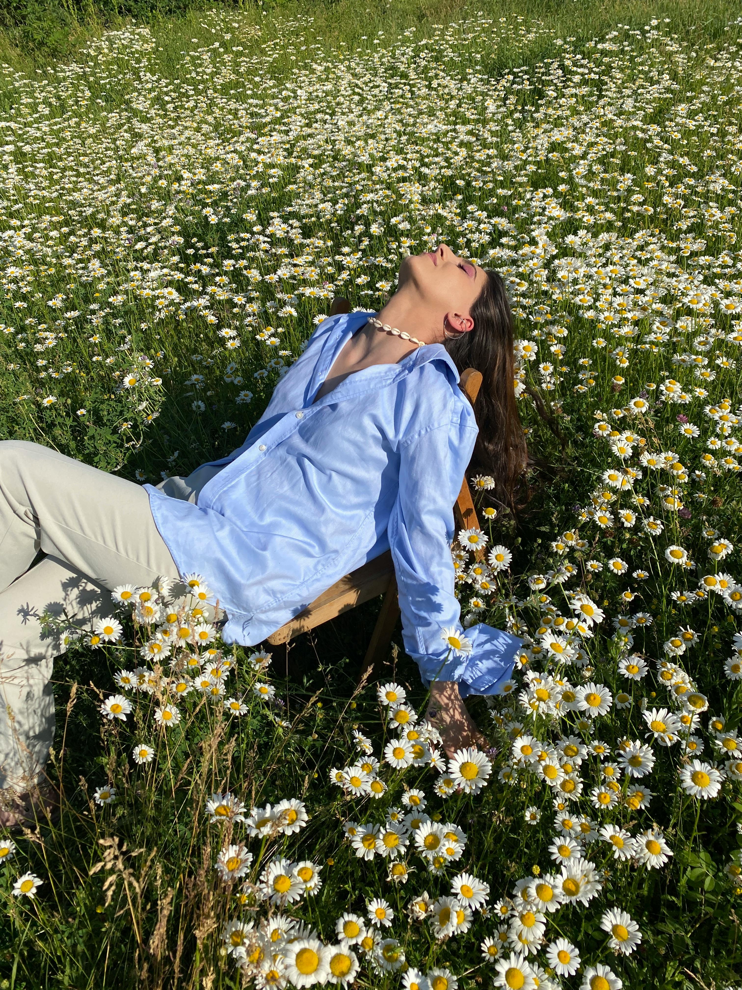 Woman Sitting on a Beautiful Flower Field · Free Stock Photo