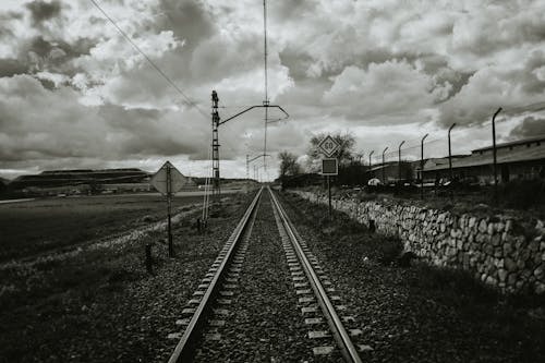 Grayscale Photograph of Train Rail