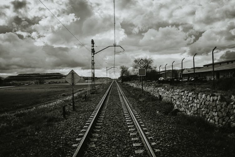 Grayscale Photograph Of Train Rail