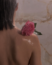 Woman With Pink Rose on Her Shoulder