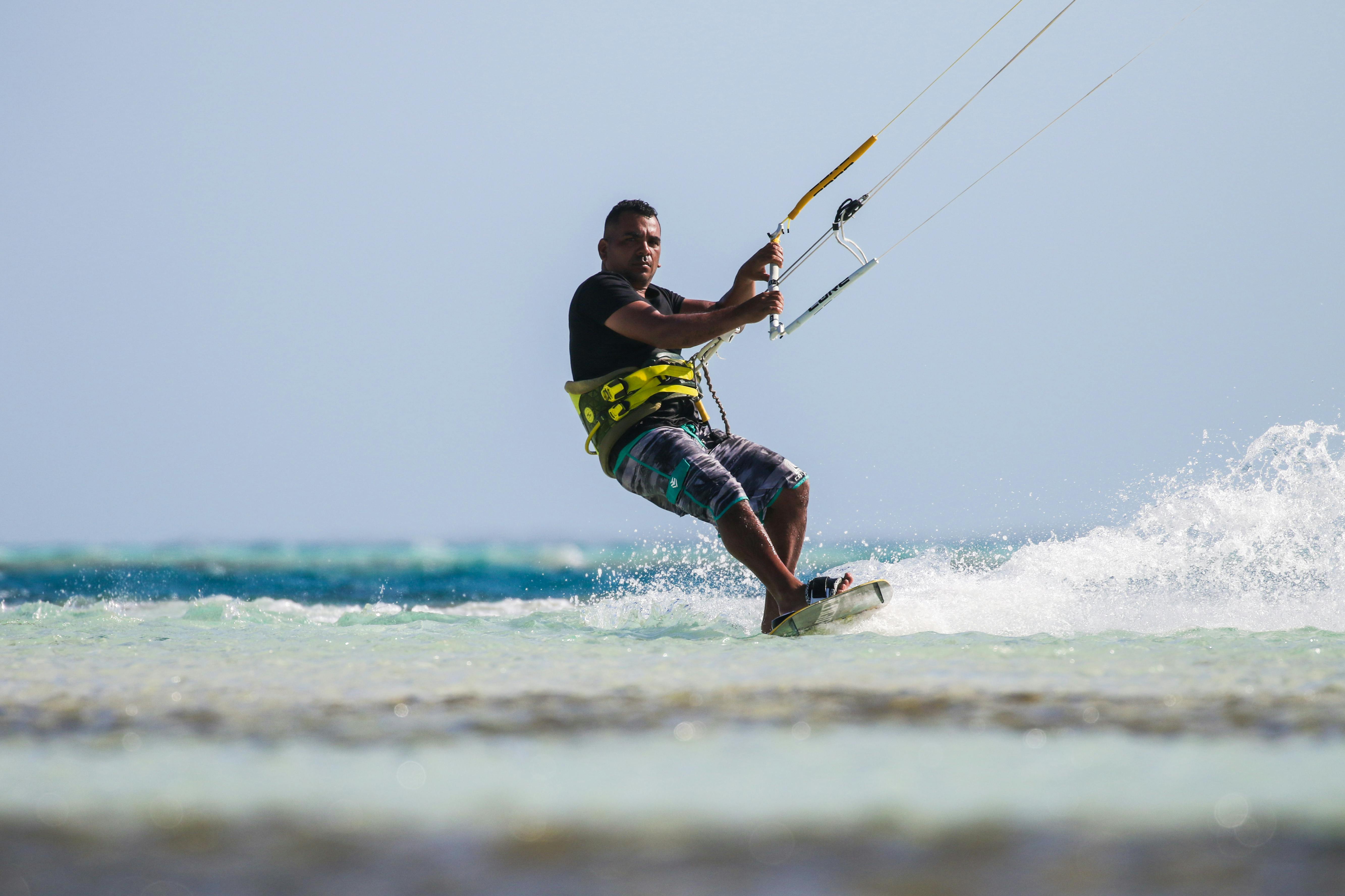 Prescription Goggle Inserts - Man enjoying kiteboarding on a sunny beach. Perfect summer action shot capturing thrill and adventure.