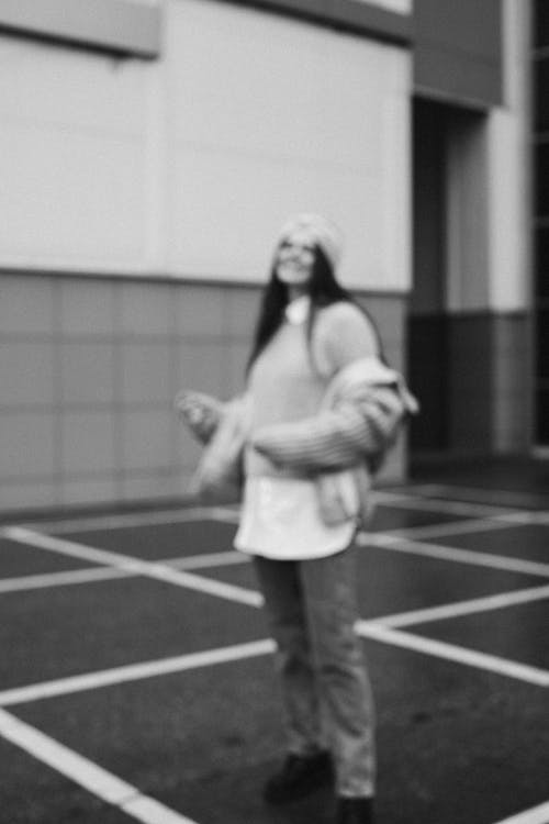 Blurred Shot of a Woman in Jacket Standing