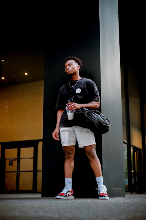 Man in Black Shirt Holding a Drink