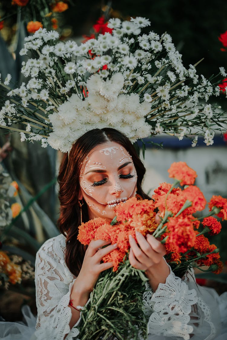 A Bride Wearing Halloween Make Up And Sniffing Flowers 