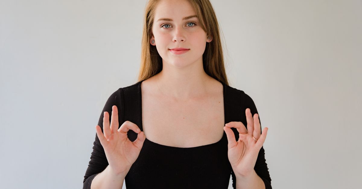 Blond Woman Using Sign Language · Free Stock Photo