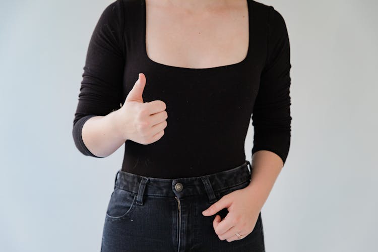 Midsection Of Woman Showing Sign Language