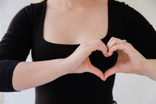 Close up on Woman Making Heart Sign