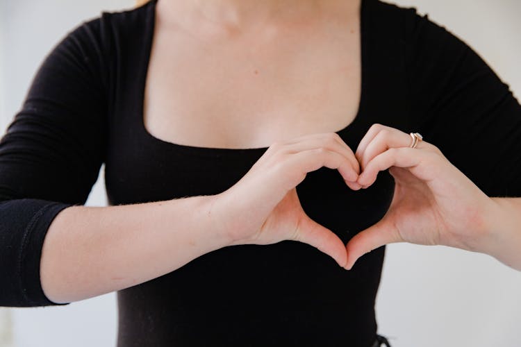 Close Up On Woman Making Heart Sign