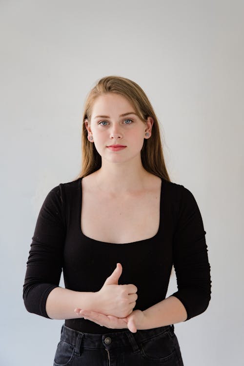 Portrait of Young Woman Using Sign Language