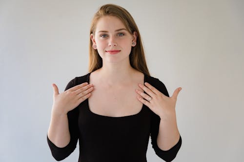 Portrait of Woman in Black Blouse Showing Sign Language Gesture