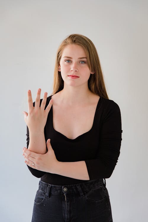 Woman Showing Sign Language Gesture with Hands