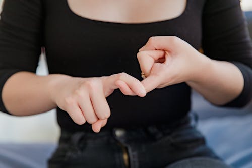 Midsection of Woman Showing Sign Language