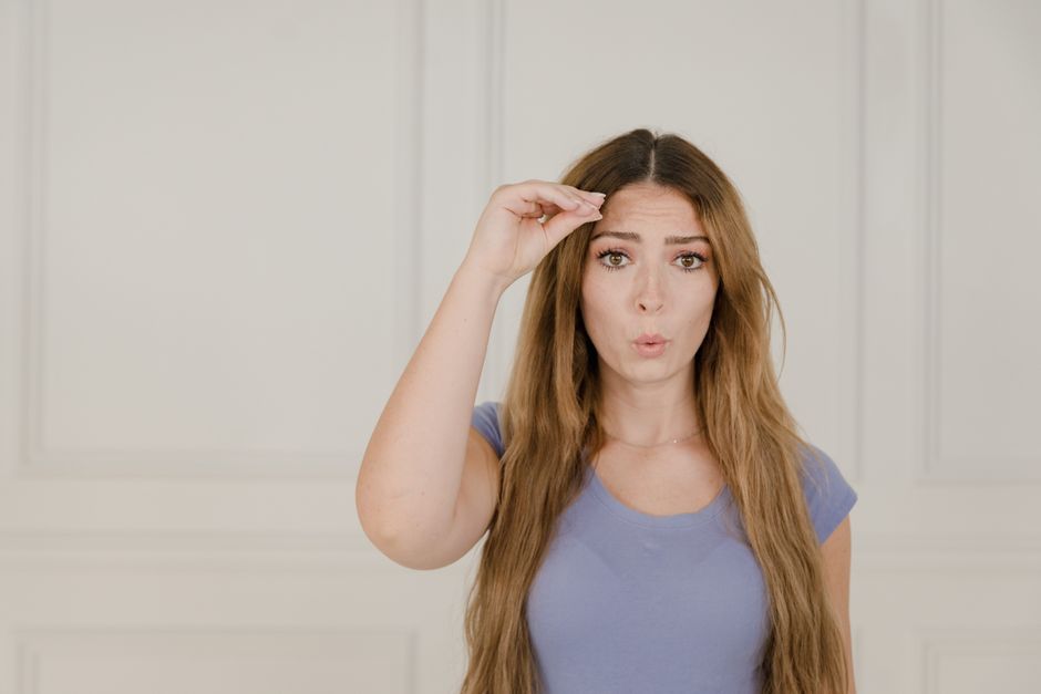Photo by RDNE Stock project on Pexels Portrait of a woman using sign language indoors, expressing communication. - Photo by RDNE Stock project on Pexels