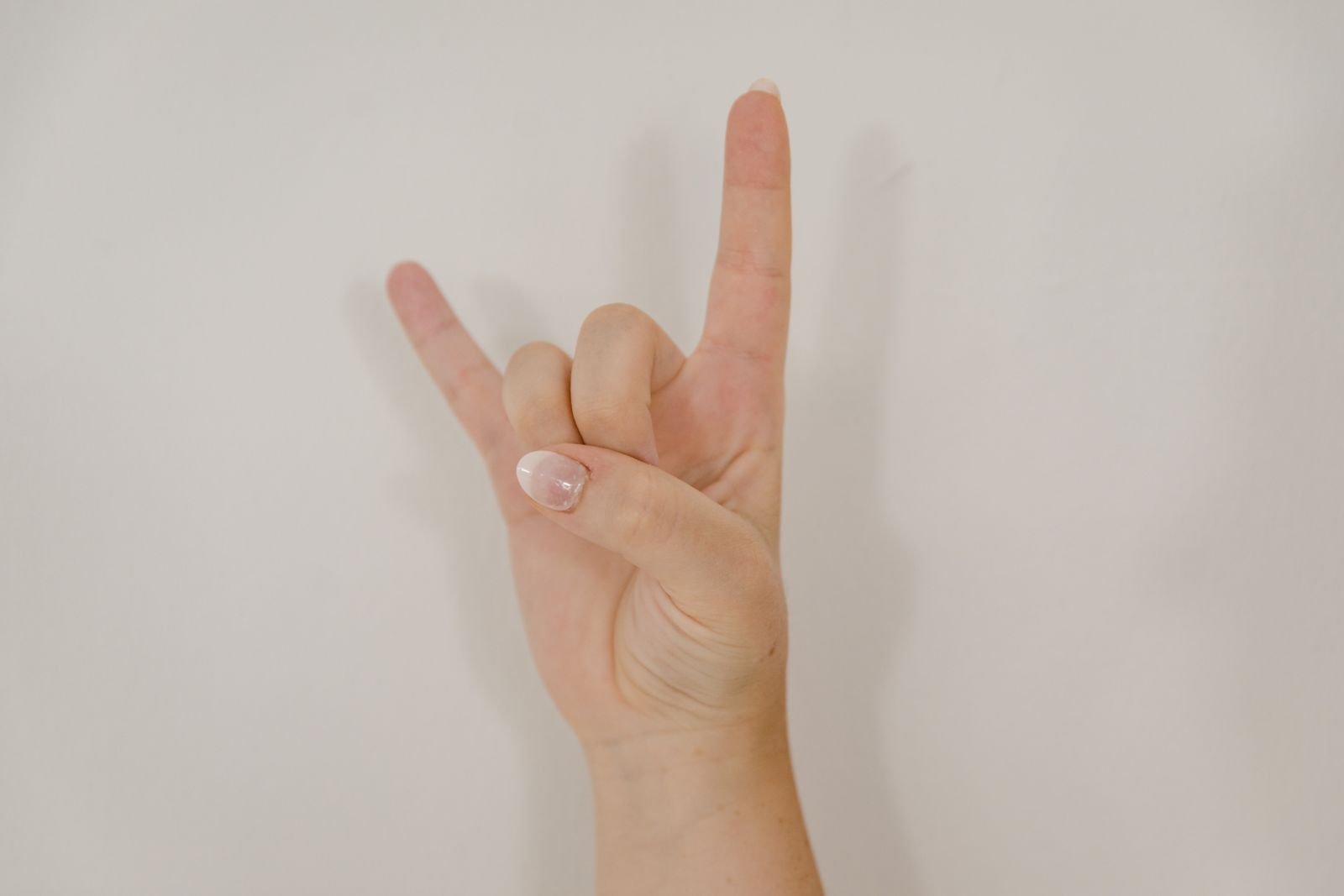 Bright close-up of hands and fingers resting on a table