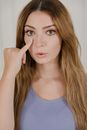 Portrait of Woman Touching Eye