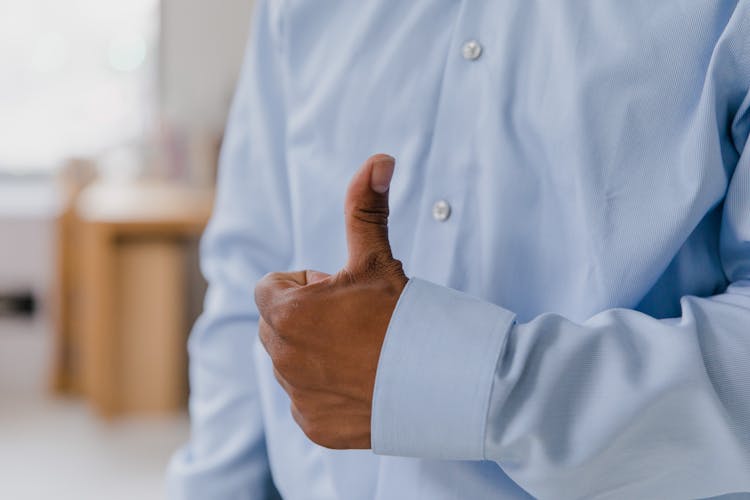 Close-up Of Businessman Showing Thumb Up Gesture