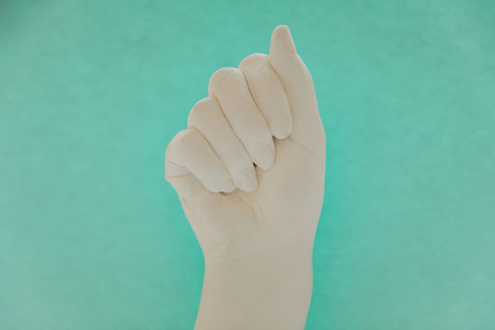 Bright close-up of hands being measured and supported for finger splint sizing
