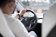 Person in White Long Sleeve Shirt Driving Car