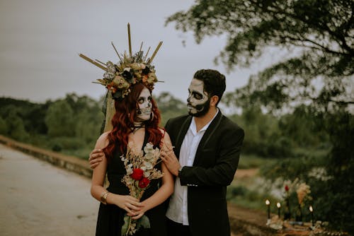 Couple with Face Paint Looking at Each Other