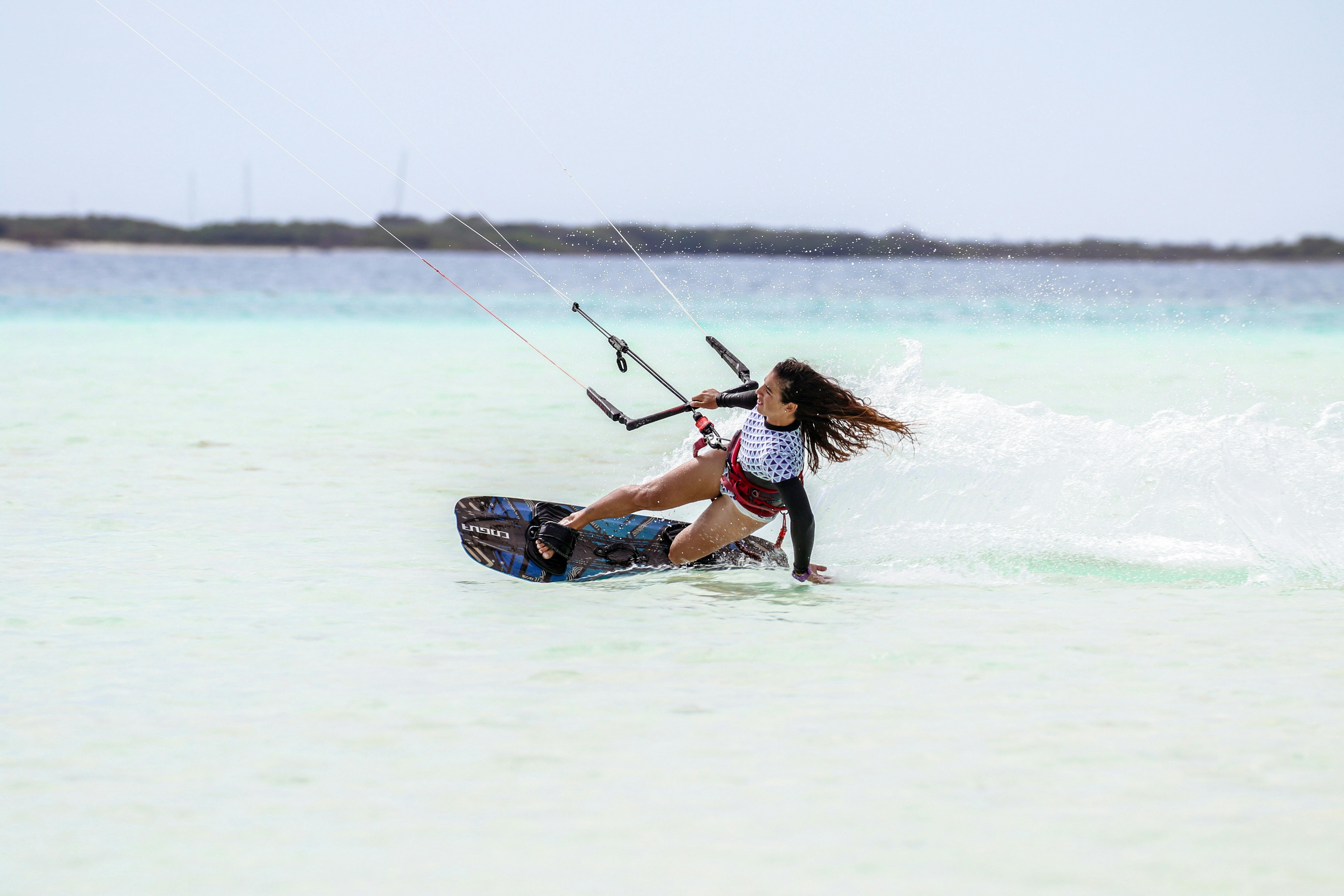 woman kitesurfing in blue sea