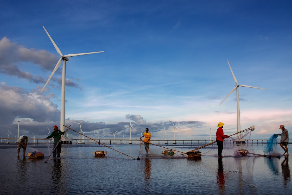 fishermen working near wind turbines