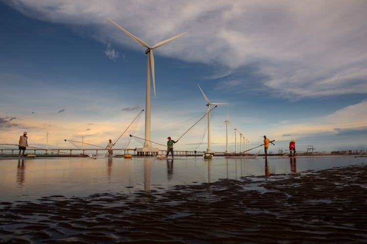 People Working Near Wind Turbines