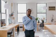Man Standing in Classroom and Making Gesture with One Hand