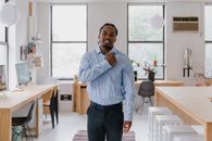 Man Standing and Making Gesture with Right Fist Touching Chest