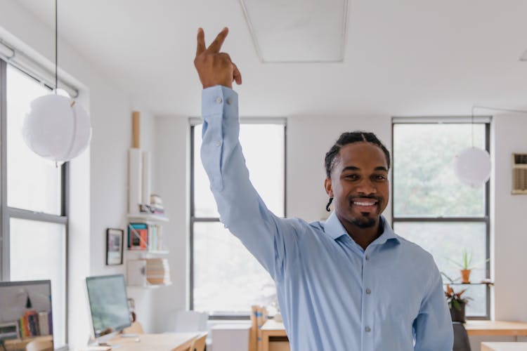 Man Standing With Right Hand Raised