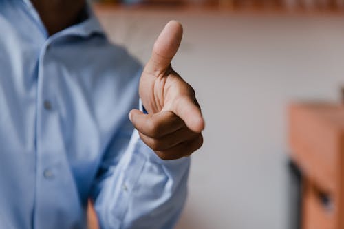 Free Male Hand Making Pointing Gesture with Stretched Forefinger and Thumb Stock Photo