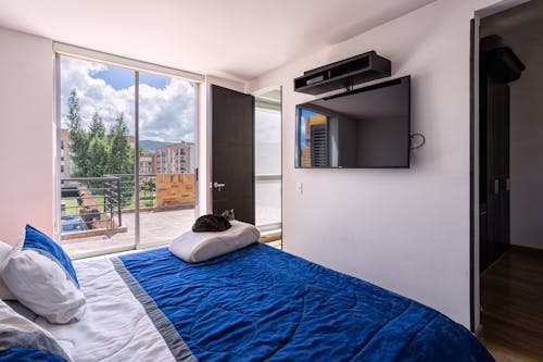 Free A Cramped Bedroom with a Balcony Stock Photo