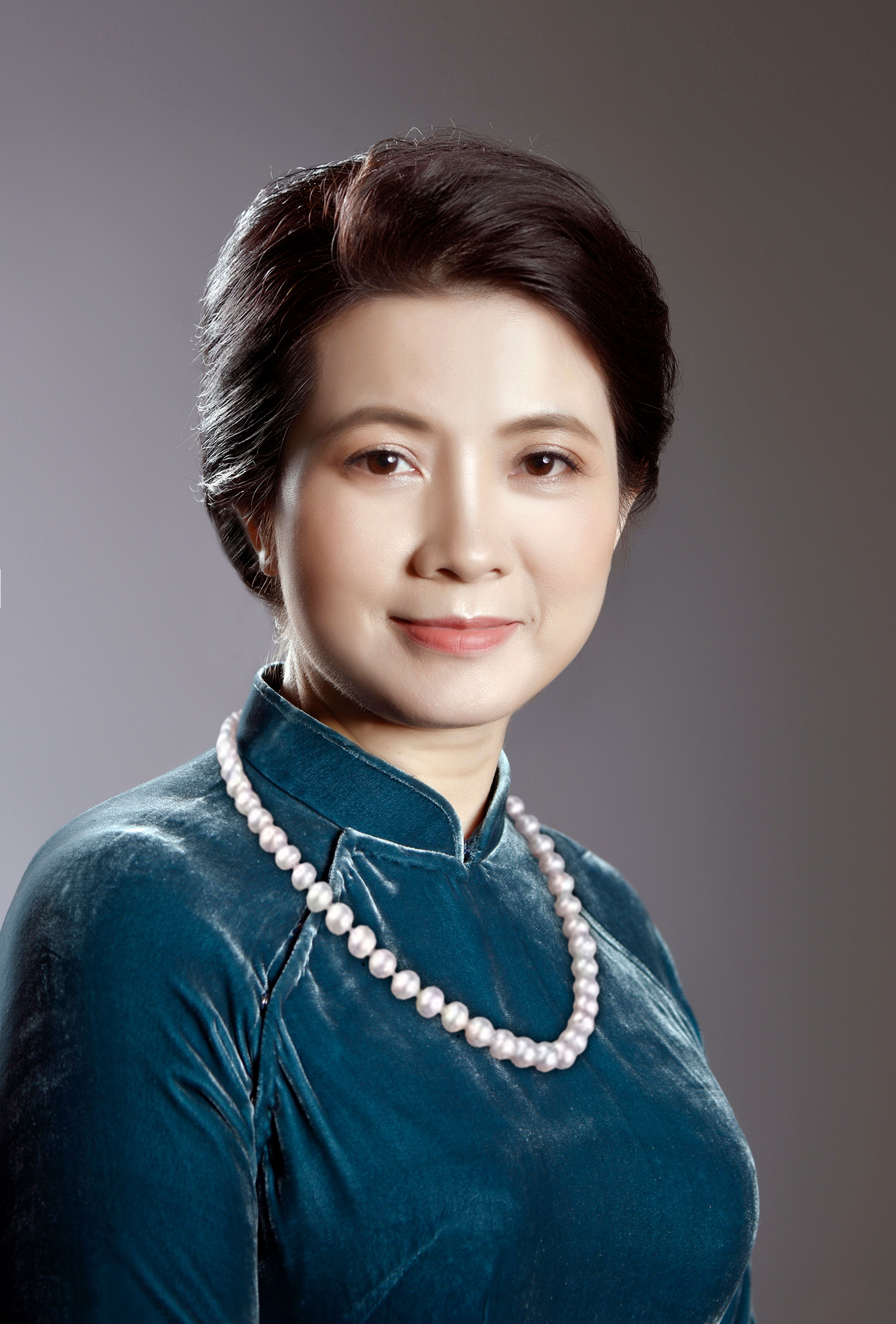 Charming studio portrait of an Asian woman wearing pearls, exuding grace and confidence.