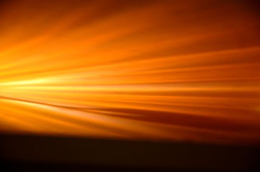 Abstract depiction of golden sun rays creating a warm, glowing effect.