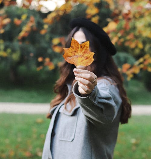 Woman Holding a Maple Leaf