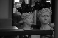 Grayscale Photo of a Pair of Head Sculptures of Women with Headdresses